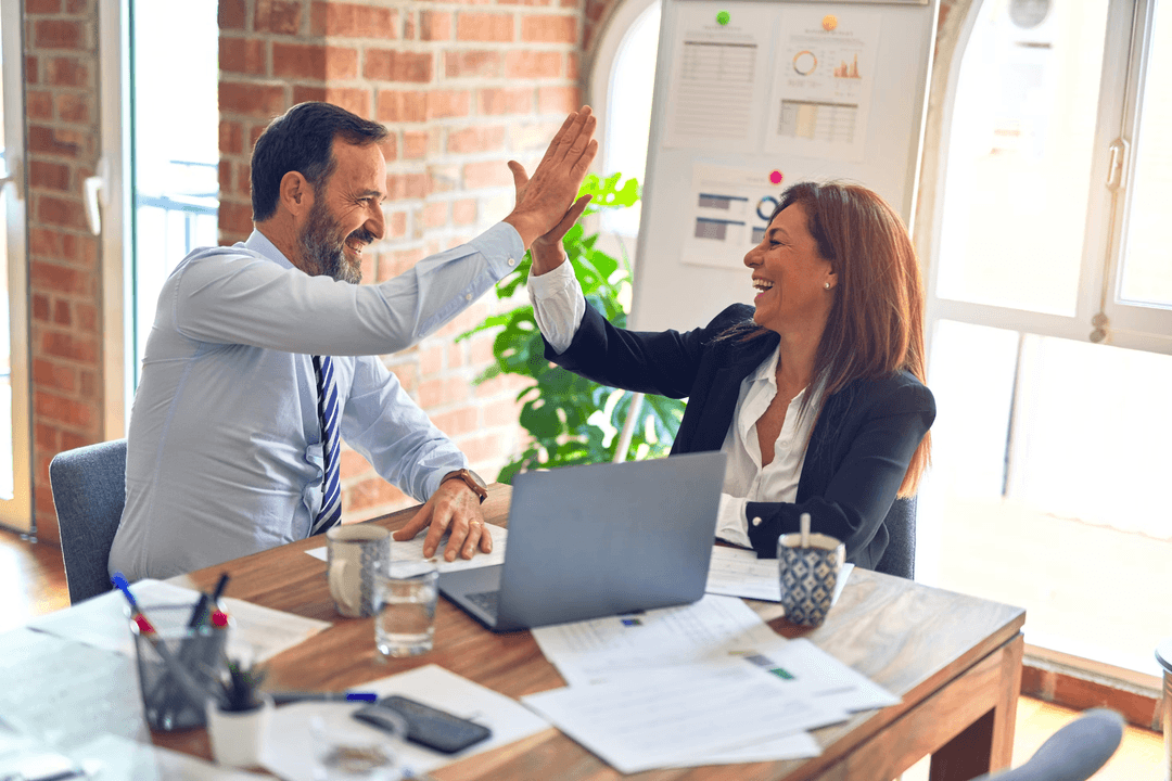 Business partners celebrating success with high five